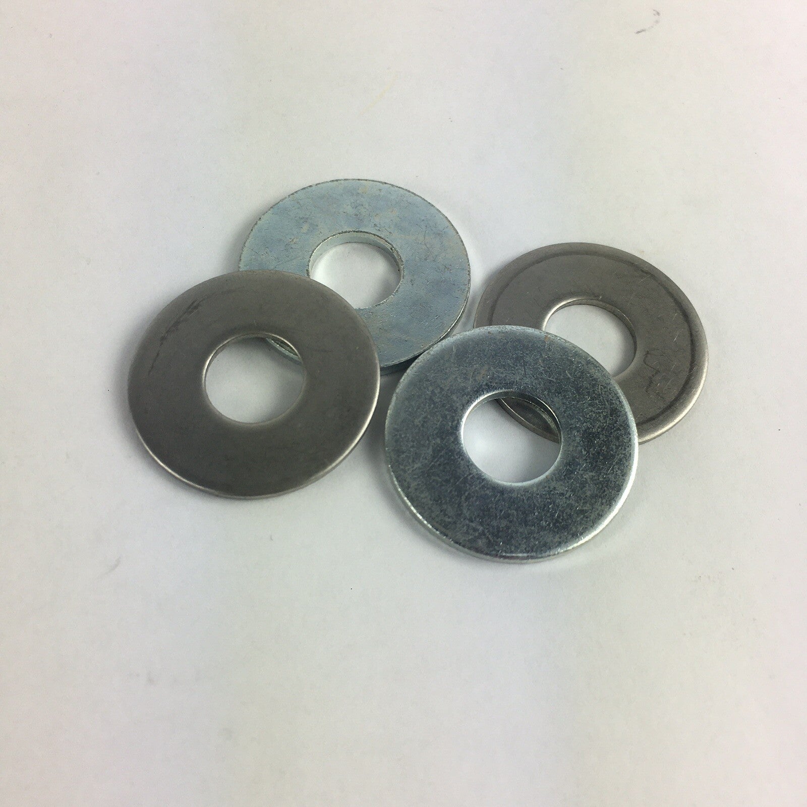 Grind King aluminum alloy flat cup washers for skateboard and longboard truck bushings and hardware replacement.