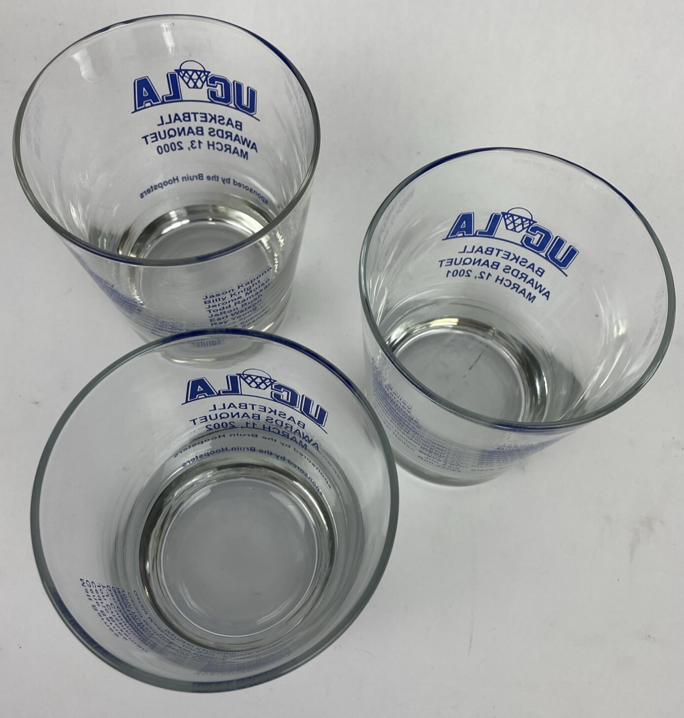Set of three UCLA Bruins Basketball Awards Banquet highball glasses from 2000, 2001, and 2002.