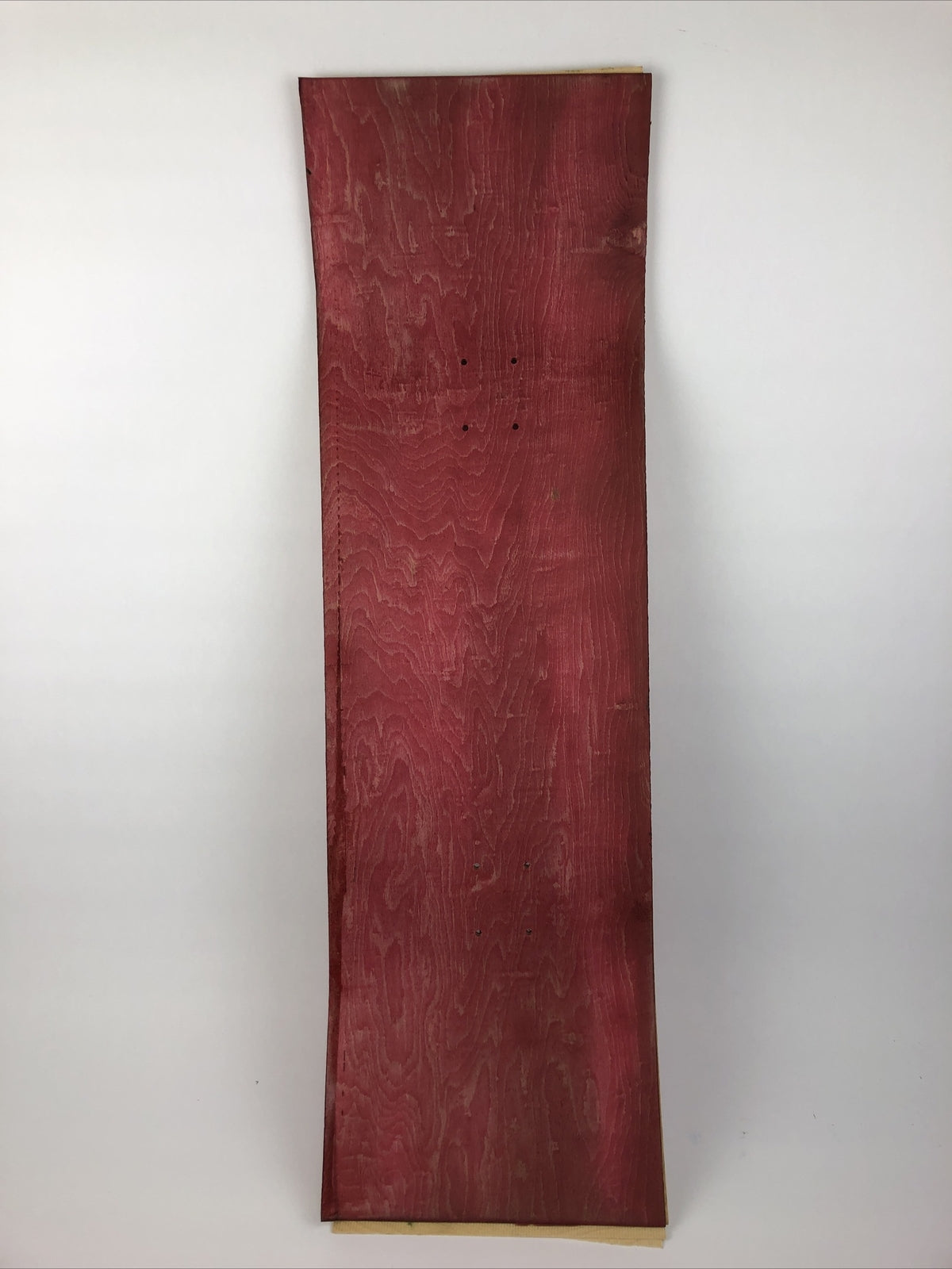 Blank uncut red stain skateboard deck 10 x 34 inches with 14.25-inch pre-drilled wheelbase.