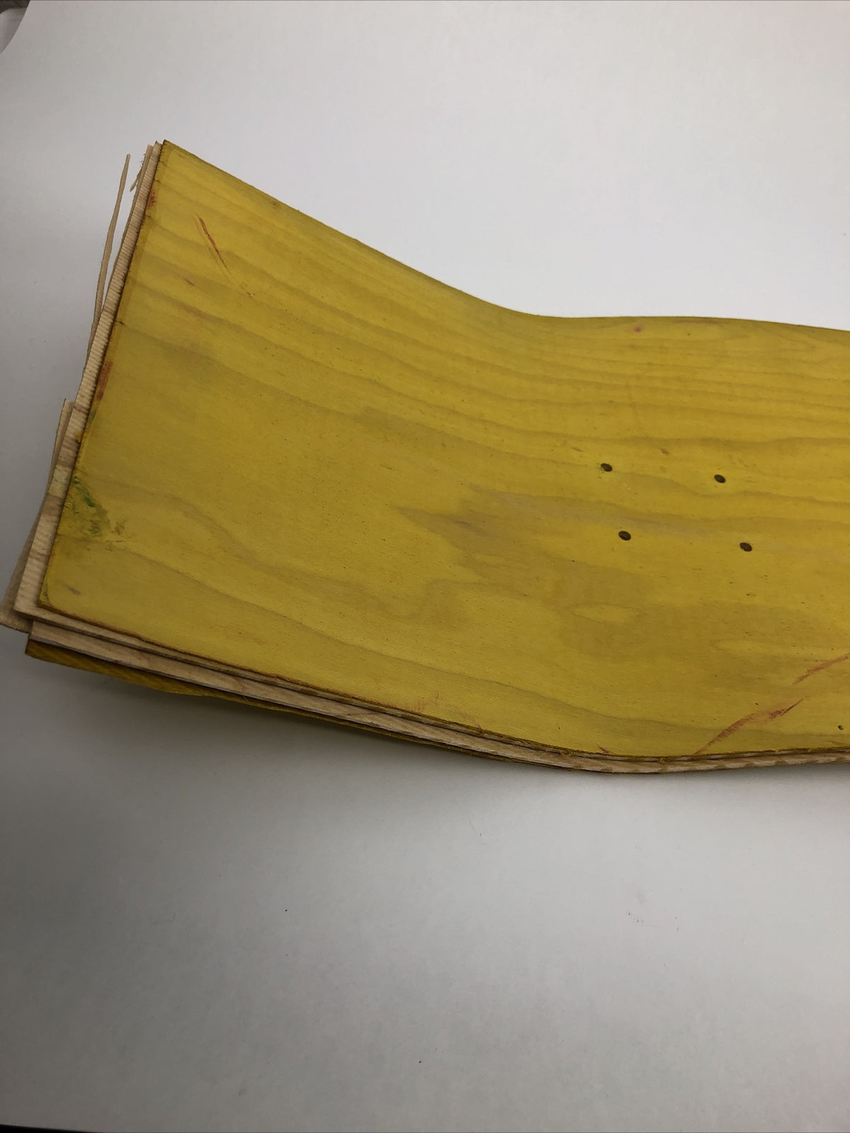 Blank uncut 10 x 34-inch yellow stain skateboard deck with 14.25-inch wheelbase.