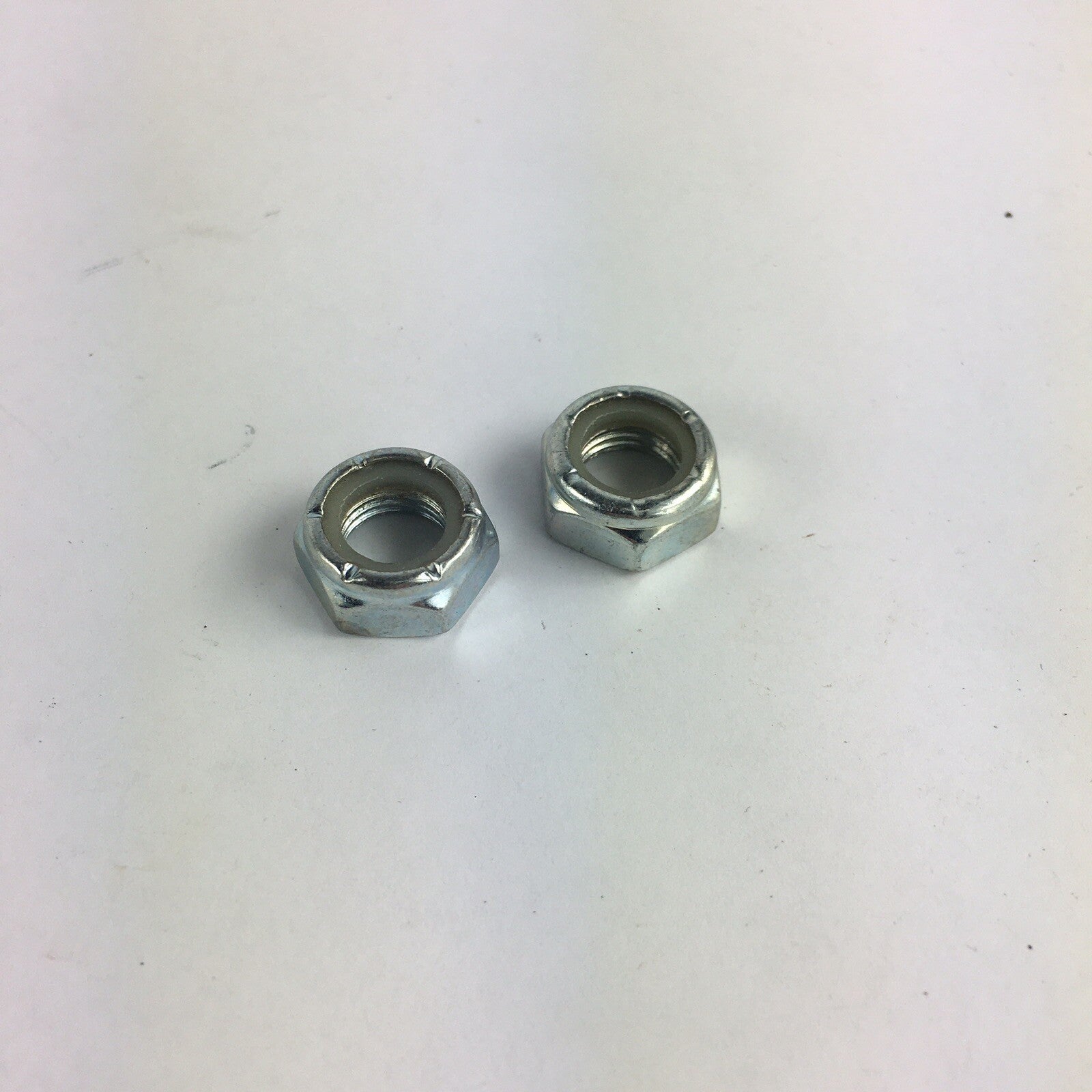 Grind King skateboard truck replacement kingpin lock nuts made from high-strength steel with nylon locking inserts.